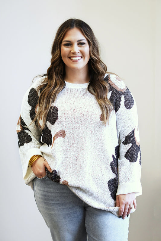 Fallon Flower Child Knit Sweater Top Round Neckline 3/4 Length Sleeves Color: Ivory w/ Black and Brown Flowers Full Length Relaxed Fit 100% Acrylic