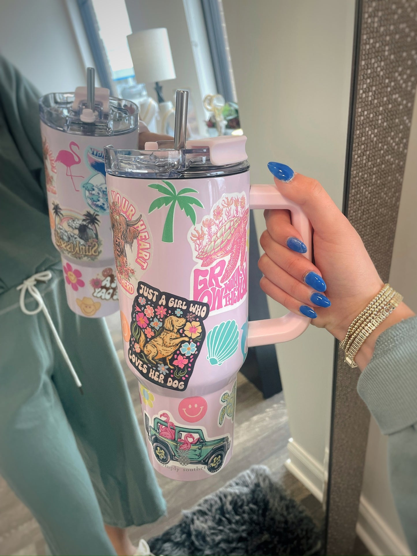 pink tumbler with handle and summer themed graphic stickers