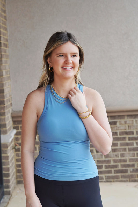 <ul> <li>Ari Athletic Racer Back Tank Top</li> <li>Halter Neckline Line</li> <li>Full Length</li> <li>Built In Bra Pads</li> <li>Butter Soft Material</li> <li>Racer Back Tank Top</li> <li>Color: Dusty Blue</li> <li>84% Poly Microfiber, 16% Spandex</li> </ul>