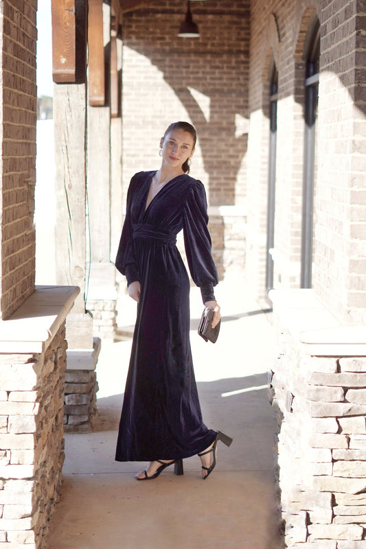 Venezia Velvet Maxi Dress Deep V-Neckline Long Cuffed Sleeves Subtle Puff Sleeves Gathered Waist Velvet Fabric Deep Blue Color Maxi Length 92% Polyester, 8% Spandex