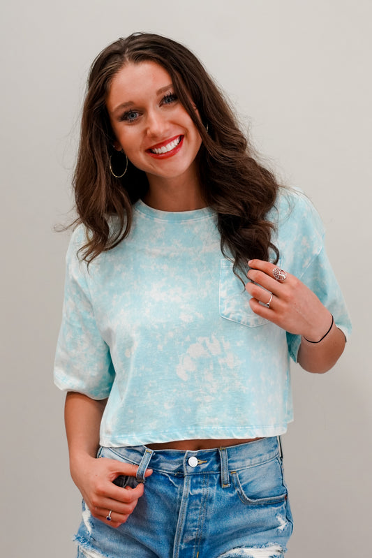 The summer humidity does horrors to your hair, and it is time for a fresh new do, so clip clip. Now throw on that cute Lauren Cropped Pocket Tee, and strut like you own the place. Lauren Cropped Pocket Tee Round Neckline Front Pocket Short Sleeves Sky Blue Color Cropped Length 100% Cotton
