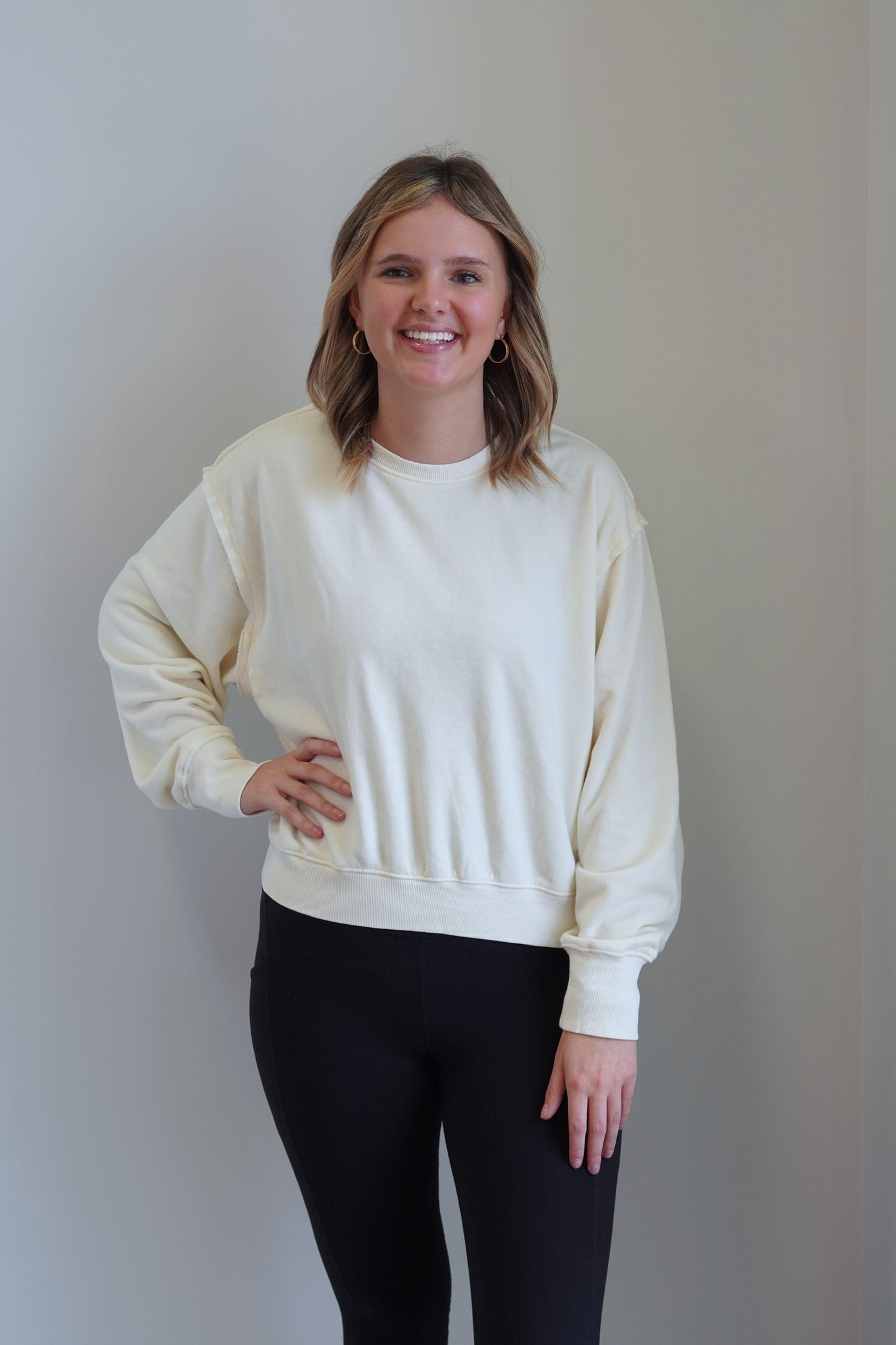 Ellie Exposed Seam Relaxed Crew Neck Crew Neckline Long Cuffed Sleeve Exposed Seam Detail Skimmer Length Colors: Cream, Relaxed Fit 80% Cotton, 40% Polyester