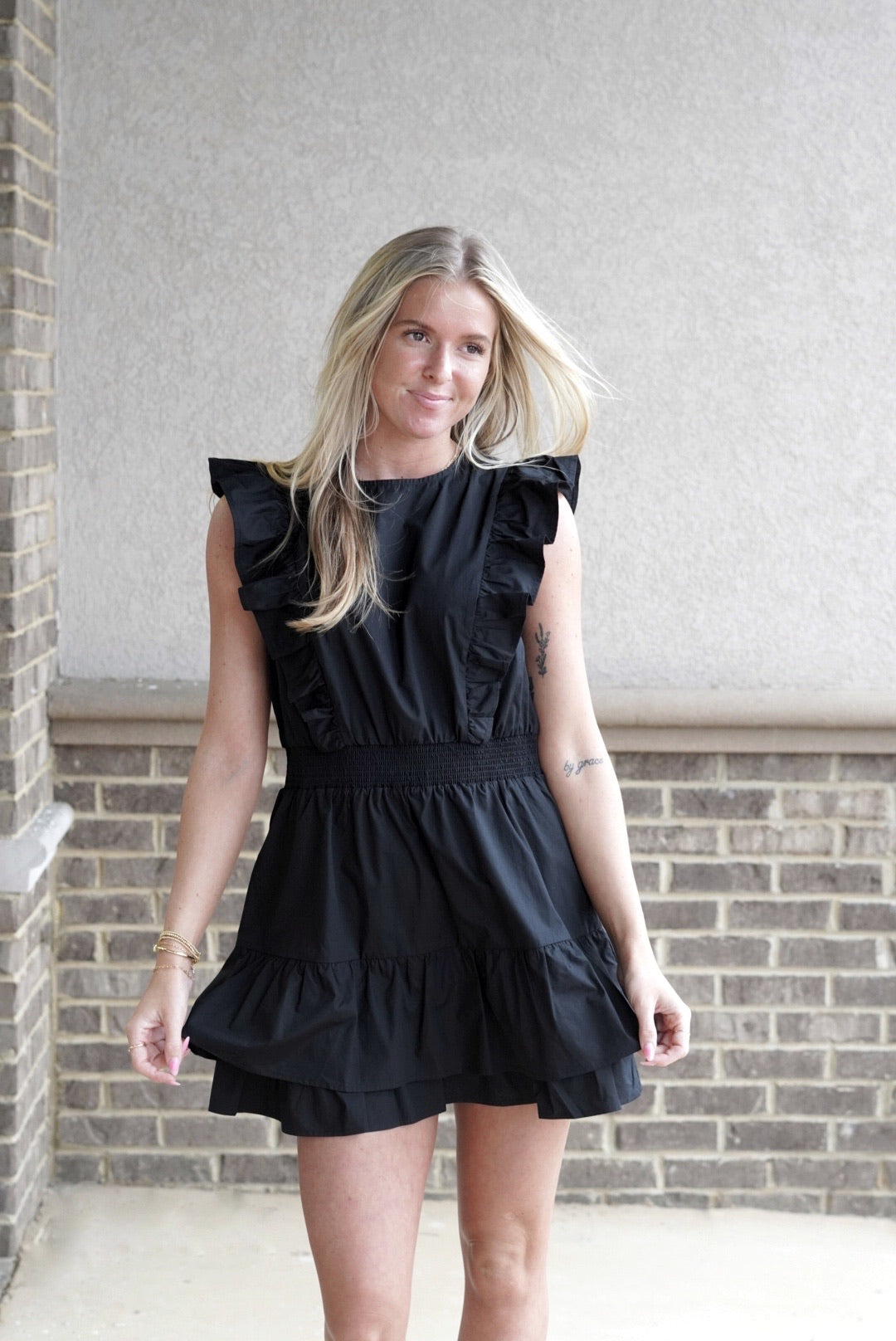 <ul> <li>Rylie Round Neck Ruffle Sleeve Dress</li> <li>Round Neckline</li> <li>Sleeveless</li> <li>Ruffle Short Sleeves</li> <li>Elastic Waistband</li> <li>Color: Black</li> <li>Mid Thigh Length</li> <li>Back Button Closure</li> <li>100% Cotton</li> </ul>