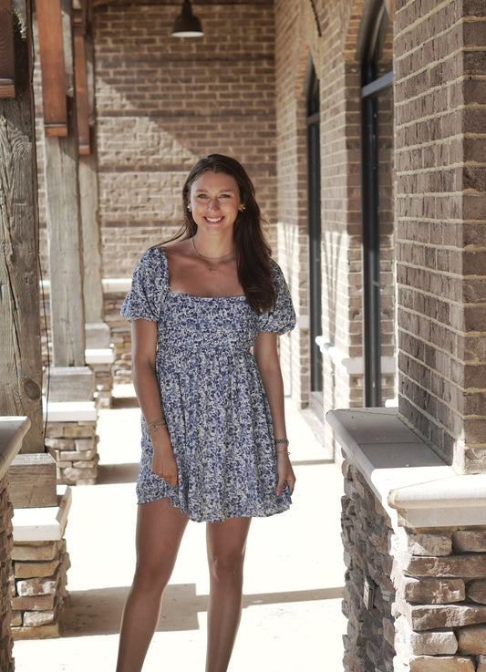 Providence Puff Sleeve Mini Dress Short Puff Sleeves Square Neckline Pleated Bodice Color: Blue Mix and White Floral Pattern Mid Thigh Length Babydoll Fit 100% Polyester