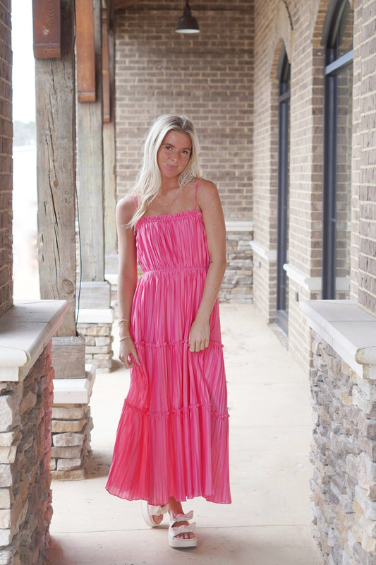 <ul> <li>The Perfect Pleated Midi Dress</li> <li>Ruffled Straight Neckline</li> <li>Adjustable Spaghetti Straps</li> <li>Pleated Material</li> <li>Tiered Ruffle Design</li> <li>Smocked Back</li> <li>Color: Pink Punch</li> <li>Pockets</li> <li>Relaxed Fit</li> <li>Midi Length</li> <li>100% Polyester</li> </ul>