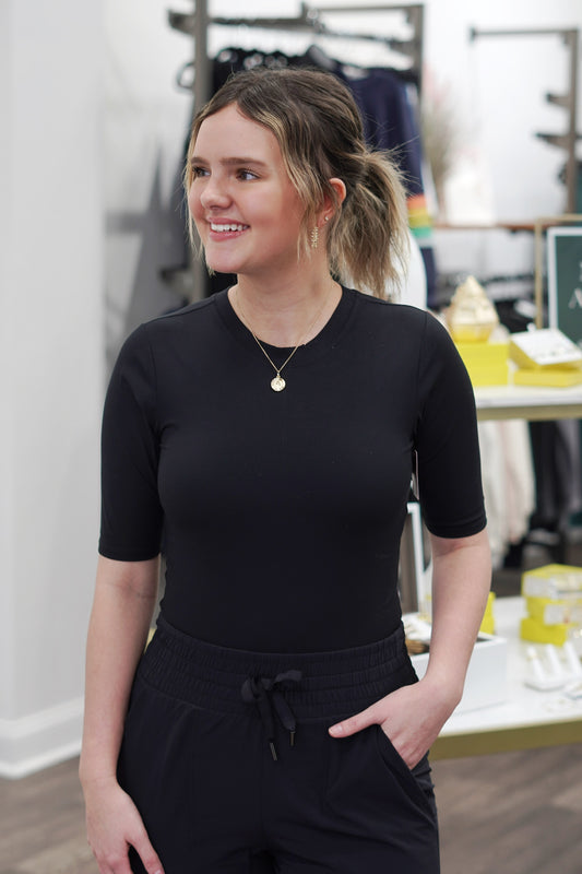 Spanx Suit Yourself Ribbed Crew Neck Short Sleeve Bodysuit Crew Neckline Ribbed Materia Snap Button Closure Bodysuit Fitted Color: Black Thong Back Body: 66% Polyester, 34% Elastane. Gusset: 100% Cotton.