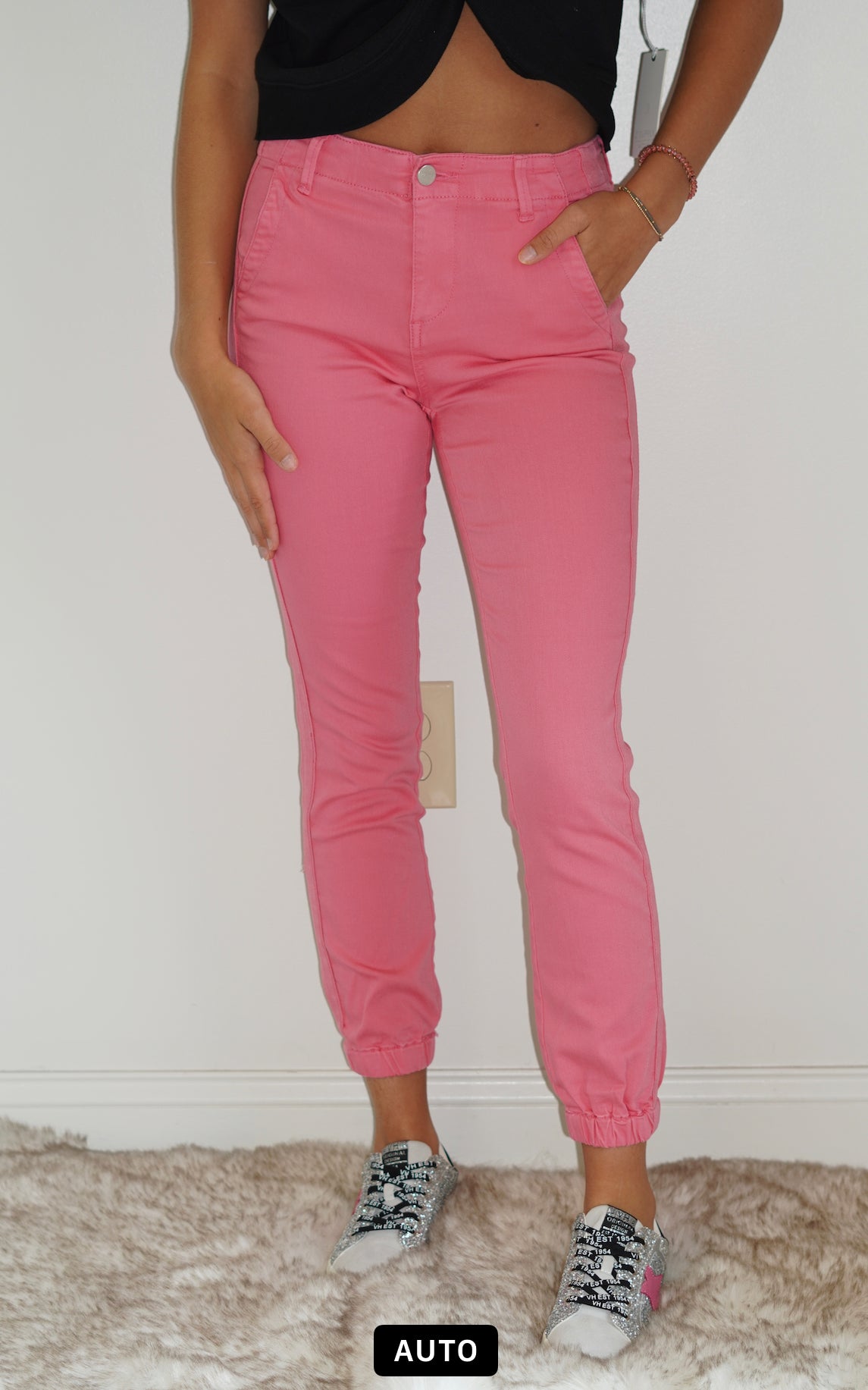 Belle High Rise Pink Jogger Jeans Cuffed Ankle Pink Line Detail Down the side Button and Zipper Closure Front and Back Pockets 92% Cotton 6% Polyester 2% Spandex Turn inside out, Machine wash cold, tumble dry low, gentle cycle with colors, Do not bleach, hang to dry, Indigo will bleed, iron if needed Model Wearing Size 1