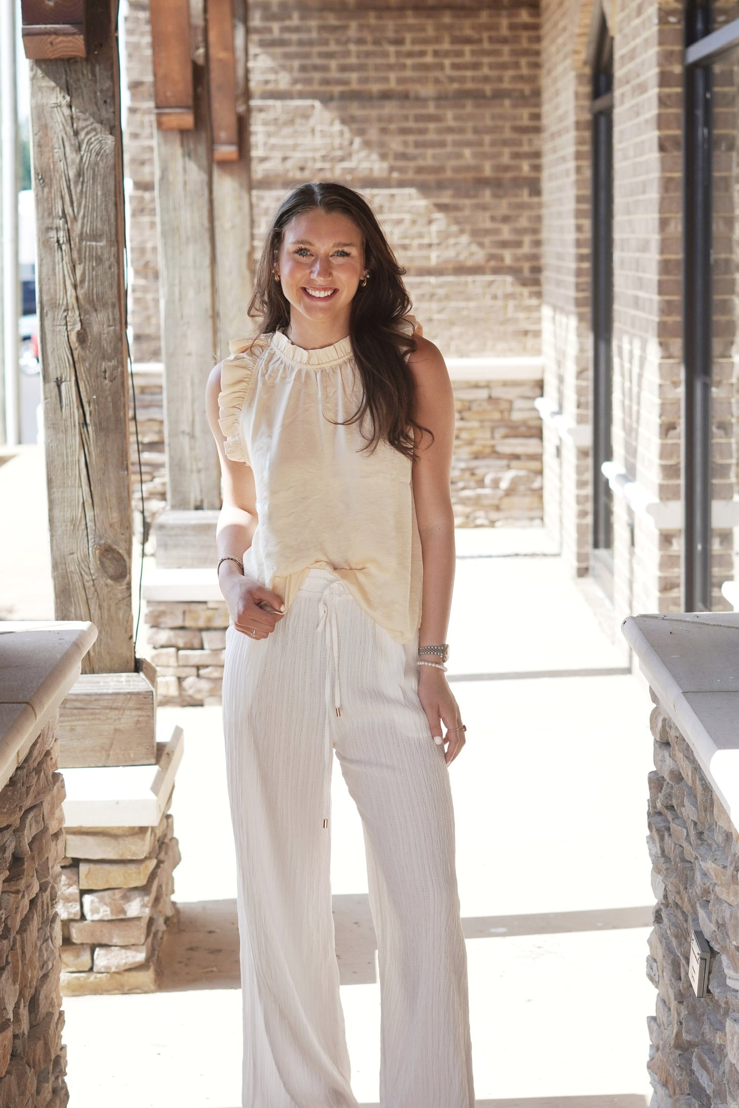 Rowan Ruffle Trim Blouse High Neckline Sleeveless Ruffle Trim Detail Color: Light Yellow Relaxed Fit Full Length 100% Polyester