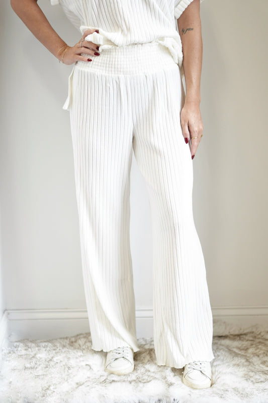 Dawn Smocked Rib Pant Smocked High Waist Full Length Colors: Bone, Ribbed Fabric Elastic Waistband Straight Leg 97% Polyester, 3% Spandex