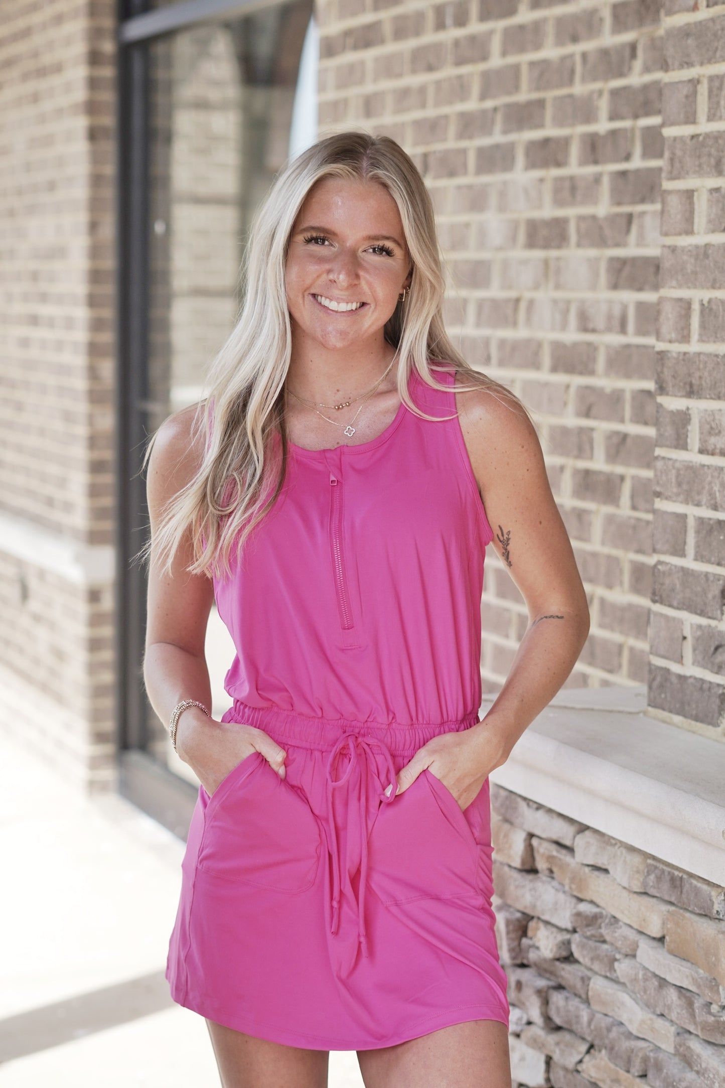 <ul> <li>So Soft Sleeveless Romper Dress</li> <li>Round Neckline</li> <li>Half Zip Up Closure</li> <li>Elastic Cinch Waistband</li> <li>String Tie Closure On Elastic Waistband</li> <li>Built In Pockets</li> <li>Built In Spandex Shorts</li> <li>Romper Dress</li> <li>Colors/ Sonic Pink, </li> <li>Relaxed Fit</li> <li>Mid Thigh Length</li> <li>Butter Soft, Light Weight Material</li> <li>True To Size</li> <li>Fabric Content: 84% Poly Microfiber, 16% Spandex</li> </ul>