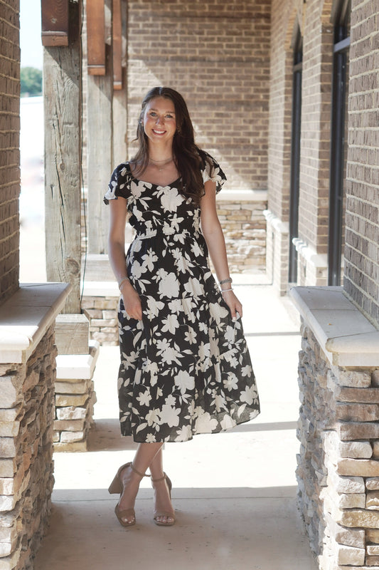 Flounce Sleeve Tiered Midi Dress V-Neckline Short Flounce Sleeves Gathered Elastic Bodice Color: Black w/ White Floral Pattern Midi Length A-Line Fit 100% Polyester