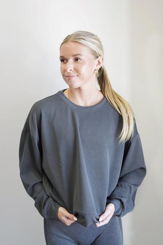 Rori Ribbed Crew Neck Pullover Crew Neckline Long Cuffed Sleeves Cuffed Hem Relaxed Fit Full Length Colors: Charcoal, 96% Polyester, 4% Spandex