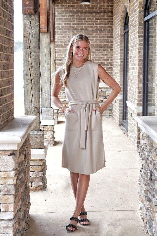 <ul> <li>Spanx Air Essentials Sleeveless Tank Dress</li> <li>Round Neckline</li> <li>Sleeveless</li> <li>Waist Tie w/ Belt Loops</li> <li>Side Slits</li> <li>Color: Tahini</li> <li>Relaxed </li> <li>Midi Length</li> <li>47 modal 46 polyester 7 elastane</li> </ul>