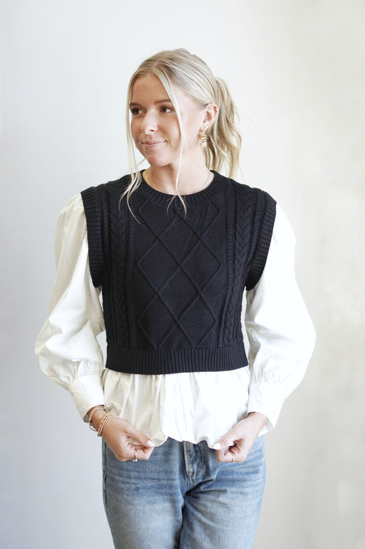 Brae Black Cable Knit Sweater Layered Shirt Crew Neckline Long Cuffed Sleeves Black Cable Knit Vest Layered Over White Shirt Relaxed Fit Full Length 100% Viscose