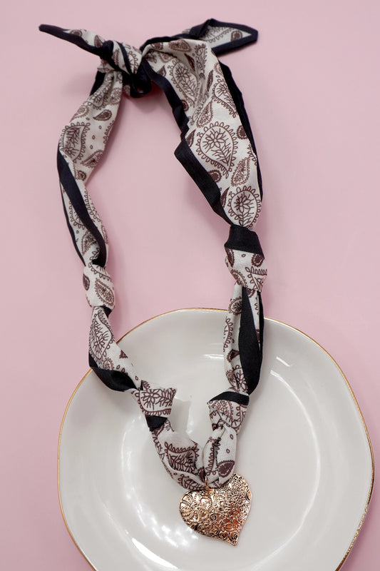 Handmade Scarf Necklace - Heart is a crafted with care, this soft fabric scarf doubles as a stylish necklace, featuring a delicate heart charm that adds a sweet, personal touch. Lightweight and versatile, it is perfect for layering.