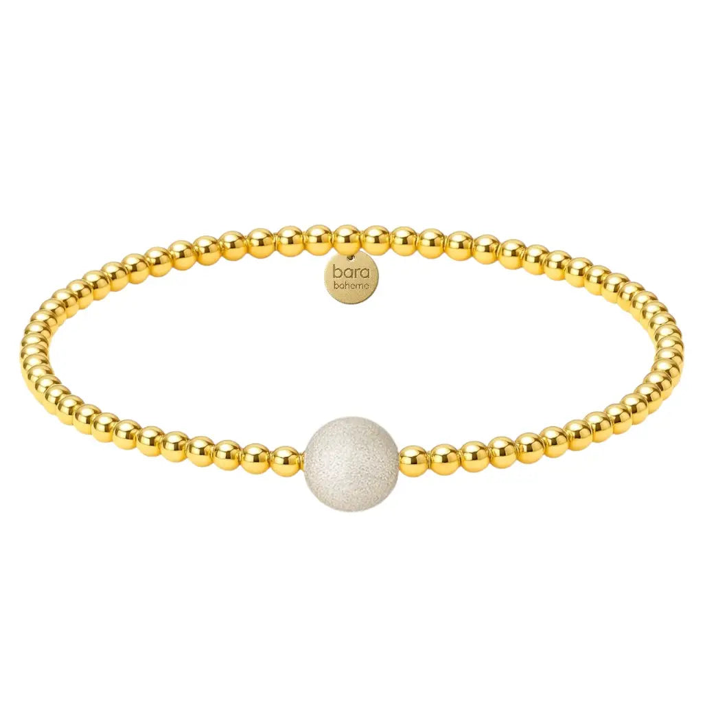 Gold beaded bracelet with one large sparkly bead