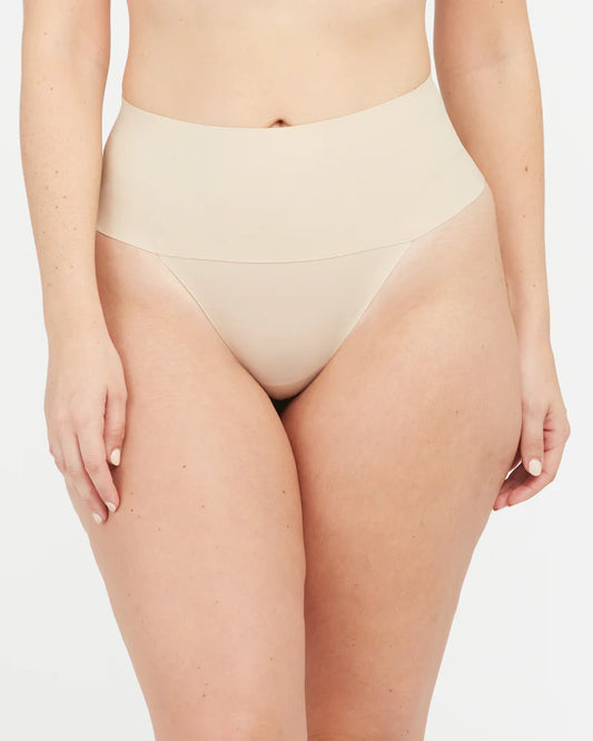 Spanx Indie-Tectable Thong Nude Rise: 26" Full coverage front, thong back 77% Nylon, 23% Elastane. Gusset: 100% Cotton. Care:Machine Wash Cold, Gentle Cycle. Only Non-Chlorine Bleach When Needed. Lay Flat To Dry. Do Not Iron.
