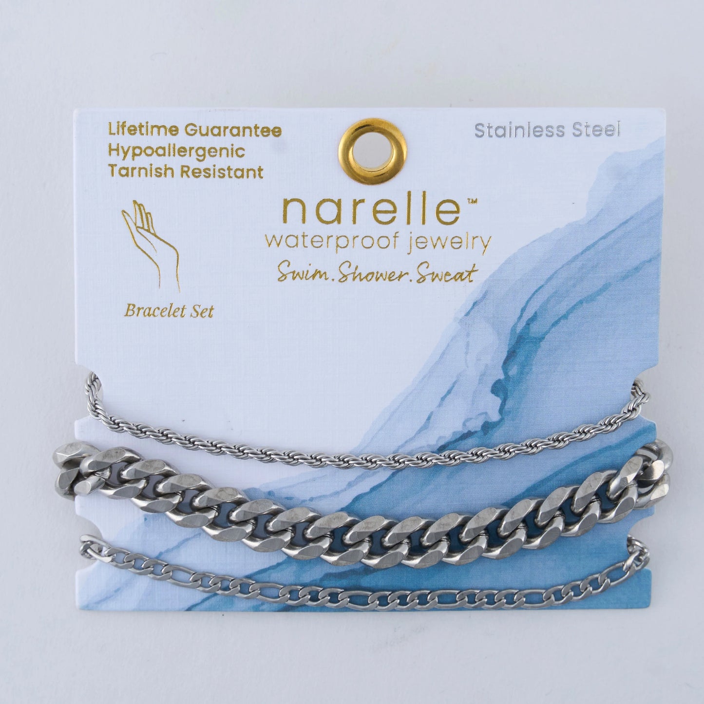 three pairs of silver bracelets in Chunky, Figaro, and Dainty Chain designs
