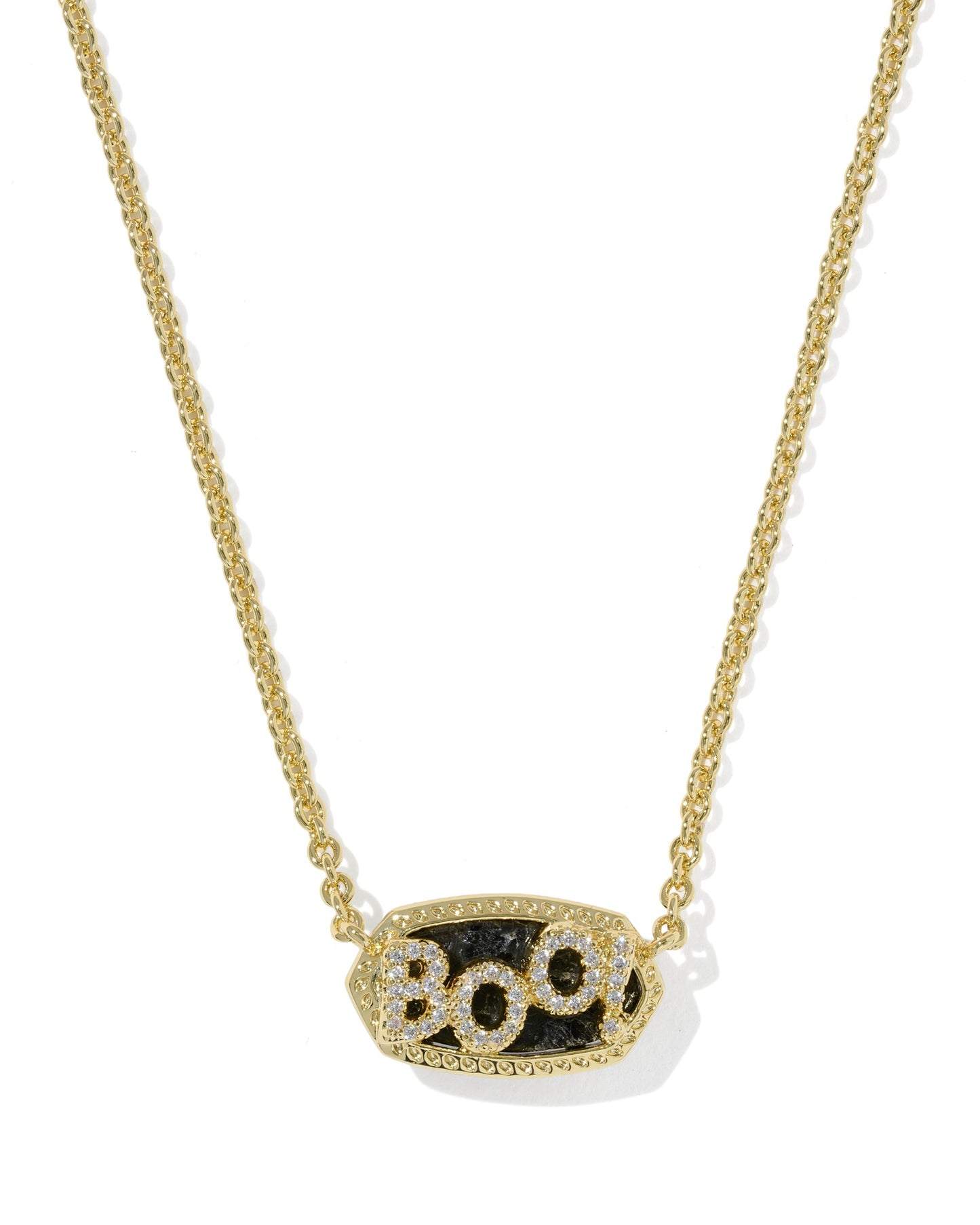 A gold chain necklace with an oval pendant featuring the word 'BOO' in sparkling clear stones over a textured black stone, shown on a clean white background.
