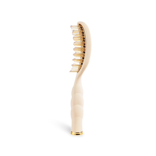 Oval hair brush, beige handle, gold aluminum plate, gentle glide bristle, textured handle with gold trim, vented, shown from the side.