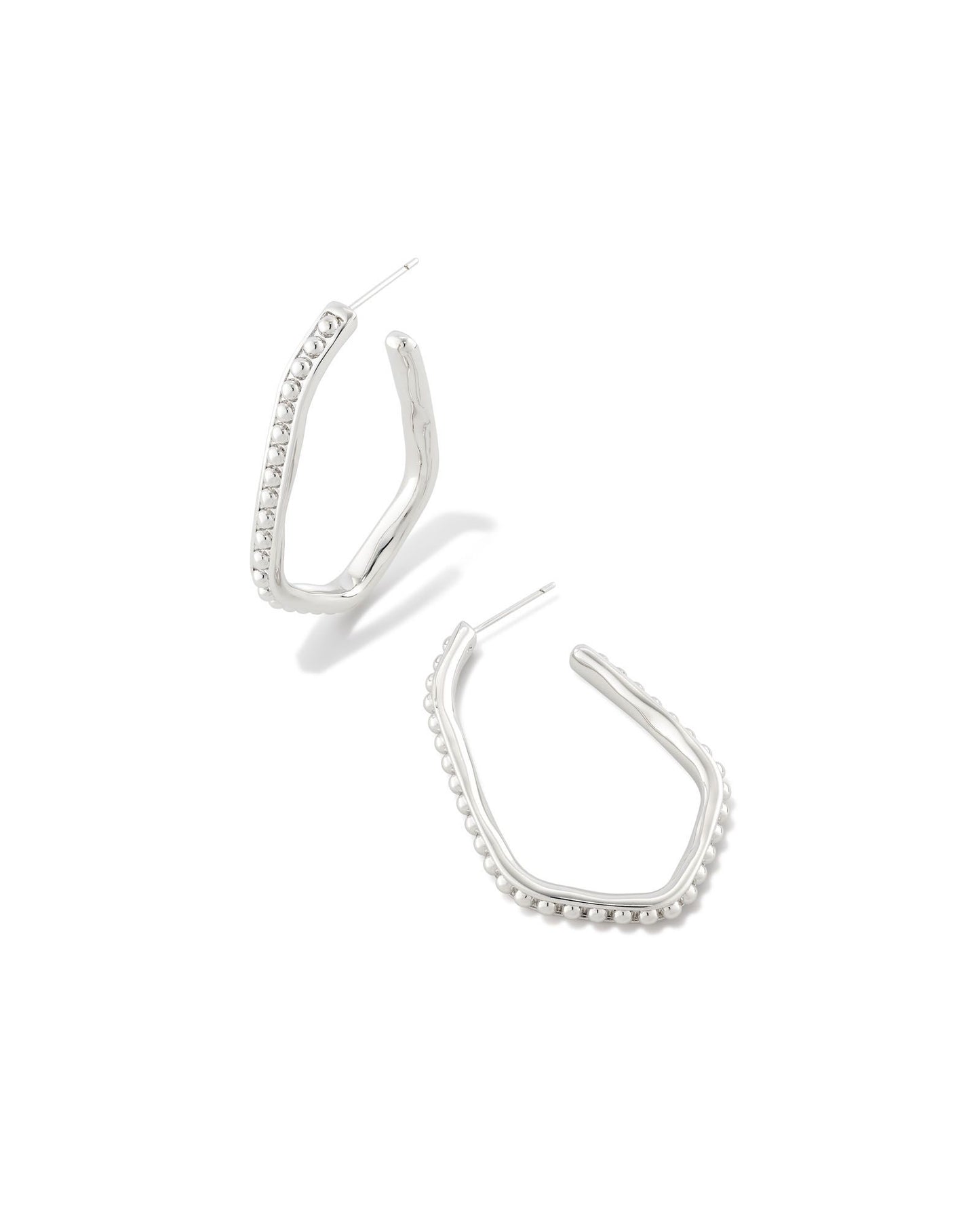 This eye-catching elongated hoop design is perfect for shaking up your look. With textured metal beads and a face-framing shape, the Lonnie Beaded Hoop Earrings in Gold go with any sense of style. These are silver colored.