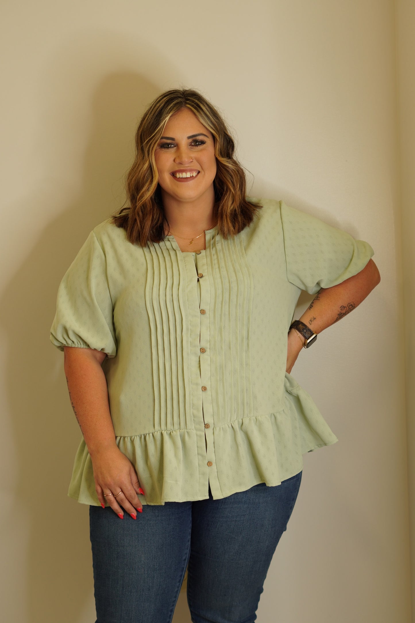 Sherry Lush Sage Blouse Textured button down Ruffle bottom Cinched sleeves 100% Polyester Hand wash cold, Do not bleach, Line dry, Iron low