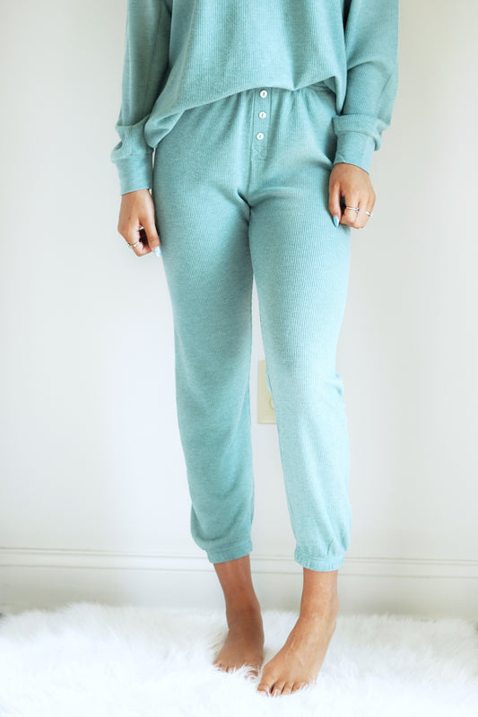 Calla Cozy Days Thermal Joggers Drawstring Elastic Waistband Full Length Legs w/ Cuffed Bottom Thermal Material Non-Functional Button Fly Washed Jade Color Relaxed Fit 64% Polyester 33% Rayon 3% Spandex