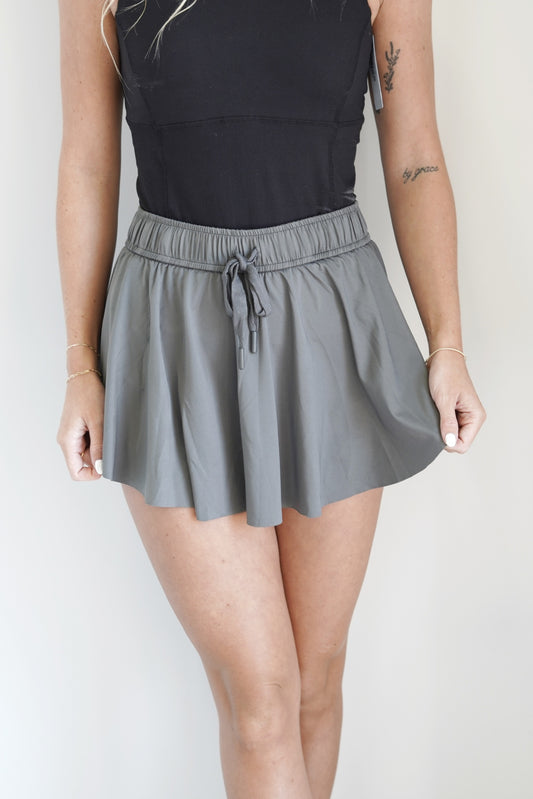 Lexia Lightweight Flowy Skort Elastic Waistline Drawstring Built In Spandex Shorts Flowy Skirt Charcoal Color 95% Polyester, 5% Spandex Hand Wash Cold, Do Not Bleach, Lay Flat To Dry, Cool Iron If Needed.