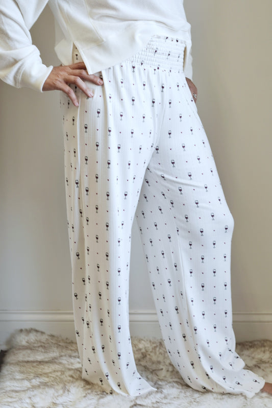 Cheers To Wine Dawn Pant Smocked Elastic Waistband Full Length Pants Wine Glass and Heart Print Bone Color Relaxed Fit Machine wash cold, wash with like colors, gentle cycle, only non-chlorine bleach when needed, lay flat to dry, iron on the reverse side or dry clean Silky Pointelle Jersey: 95% Polyester 5% Spandex