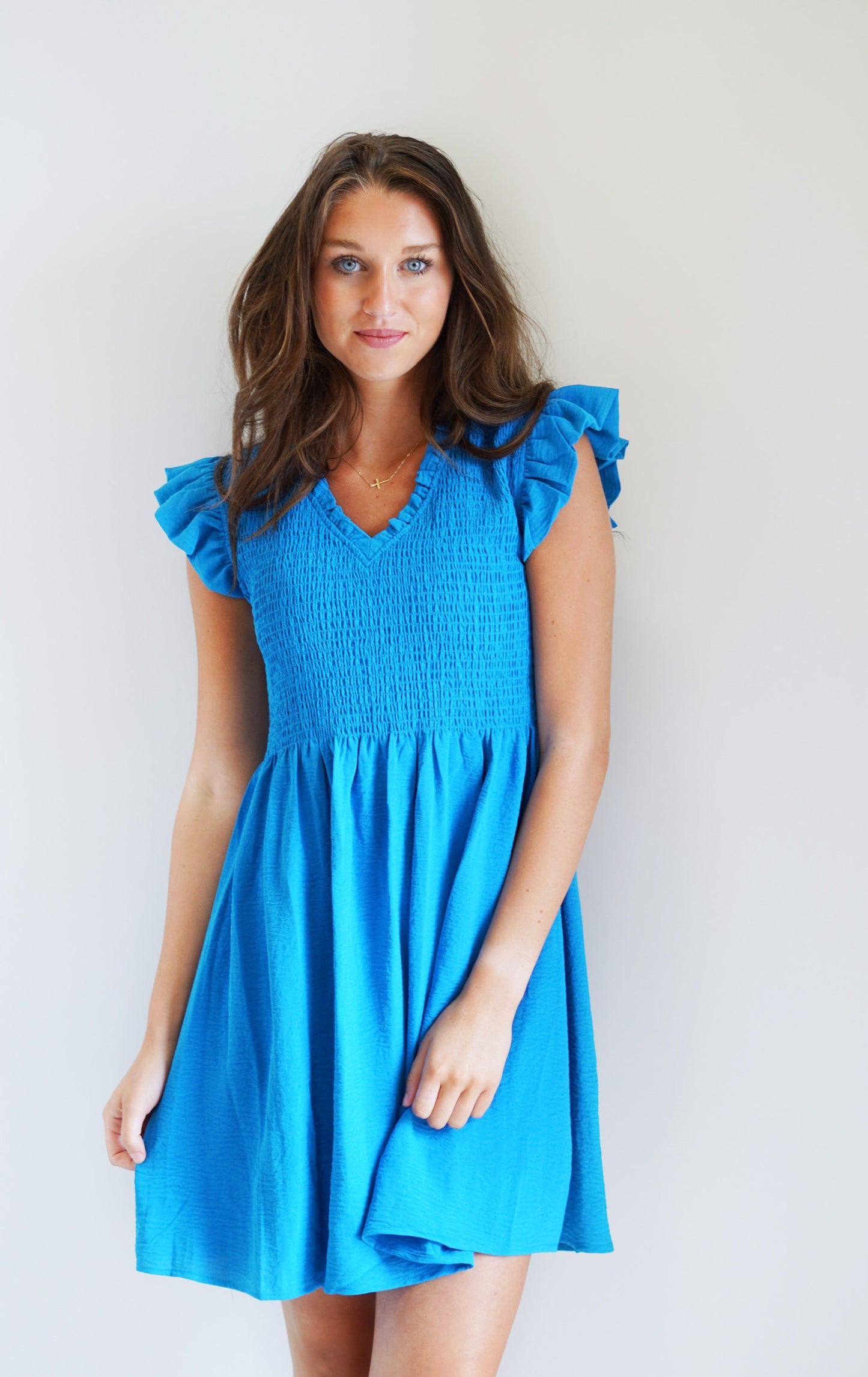 Tiffany Turquoise Ruffled Dress V Neck Line Ruffle Short Sleeve Textured material on top half Turquoise Knee Length Dress 100% Polyester Hand Wash Cold,Line Dry Model is wearing size: Small