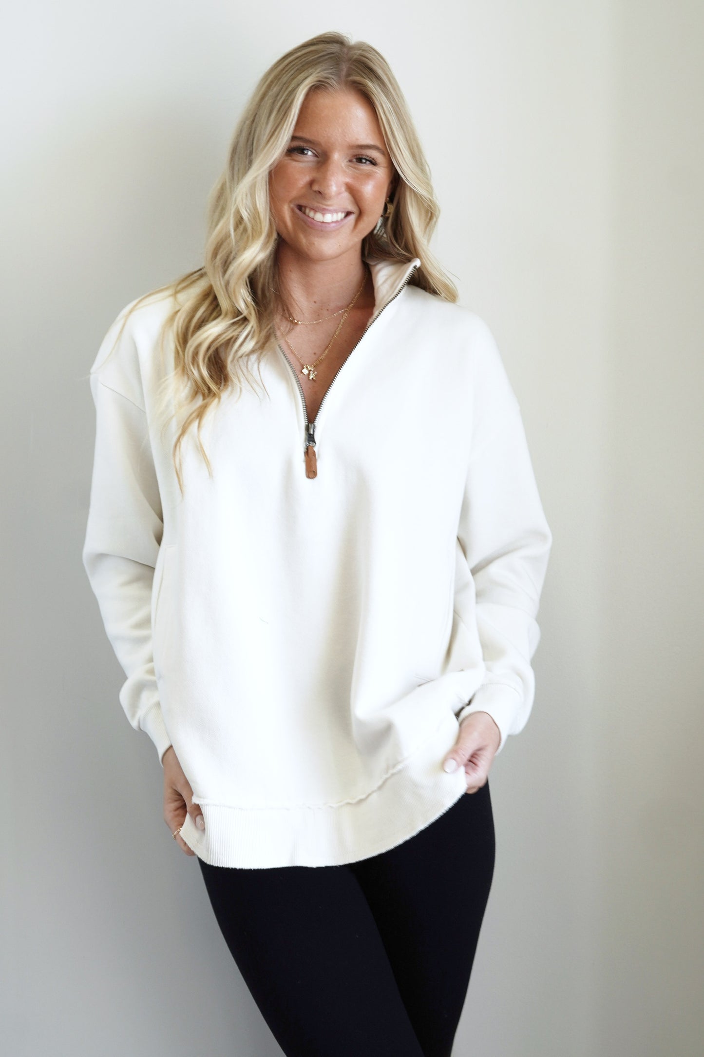 Kenz Quarter Zip Pocket Pullover Collared Zip Up Neckline Long Cuffed Sleeves Front Pockets Ribbed and Raw Hemline Colors: Cream Full Length Relaxed Fit 58% Polyester, 42% Cotton