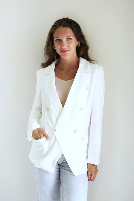 Doesn't everyone want to look like Blaire Waldorf from Gossip Girl? This Petticoat style blazer is totally her vibe! Pair it with some nude heels and that clutch of yours for a stylish Upper East Side Look! Blaire Button Petticoat Style Blazer Collar and Lapel Neckline Long Sleeves w/ Button Details Front Pockets White Antique Printed Buttons 100% Polyester Model is wearing size small
