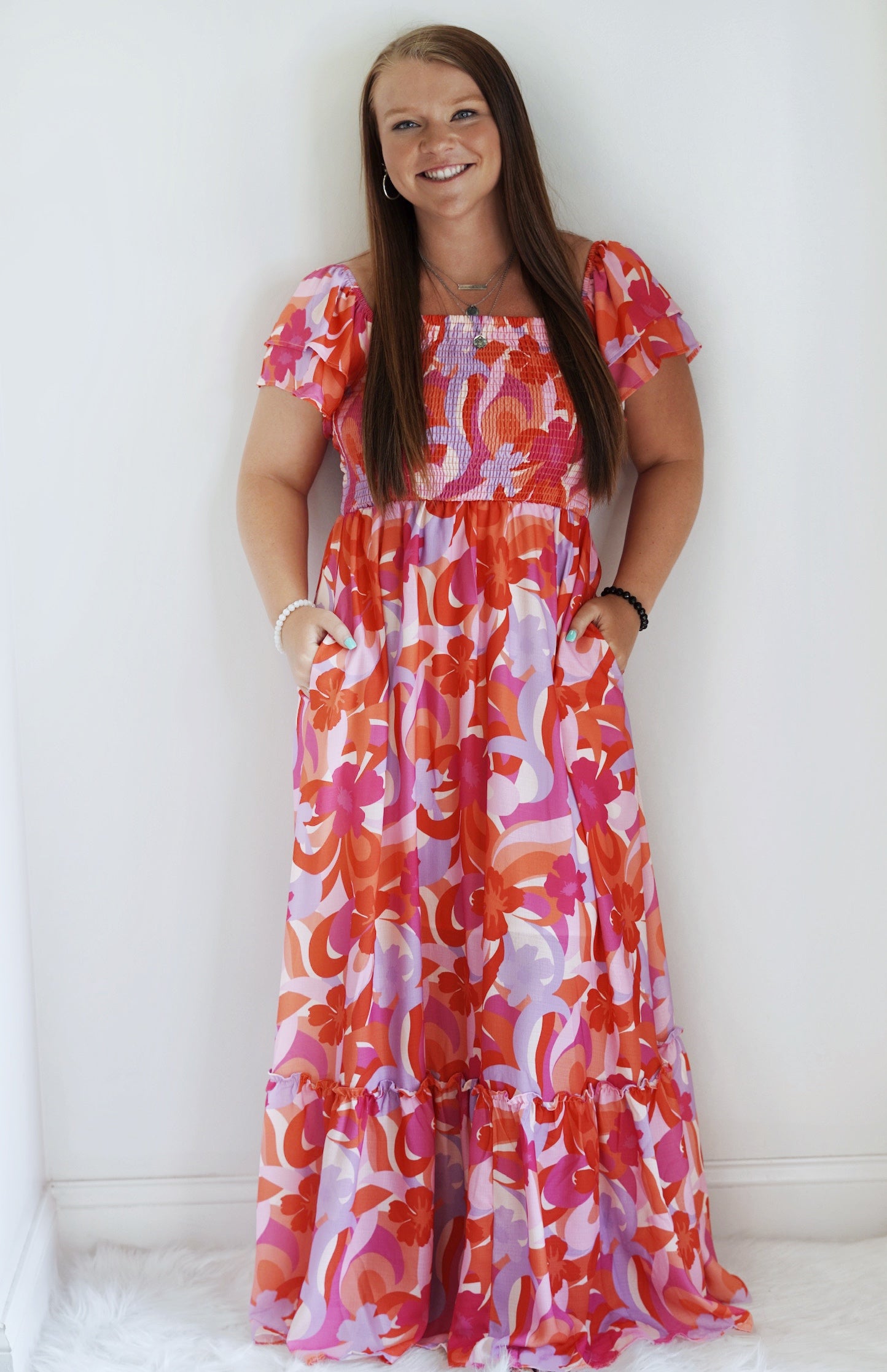 Anna Floral Smocked Maxi Dress Double Sleeve Smocked Elastic cinched Top Flow Bottom With Ruffle Pink/Purple/Floral 100% Polyester Hand Wash Cold, Do not Bleach, Hang Dry, Low Iron if needed Model Wearing Size: Small