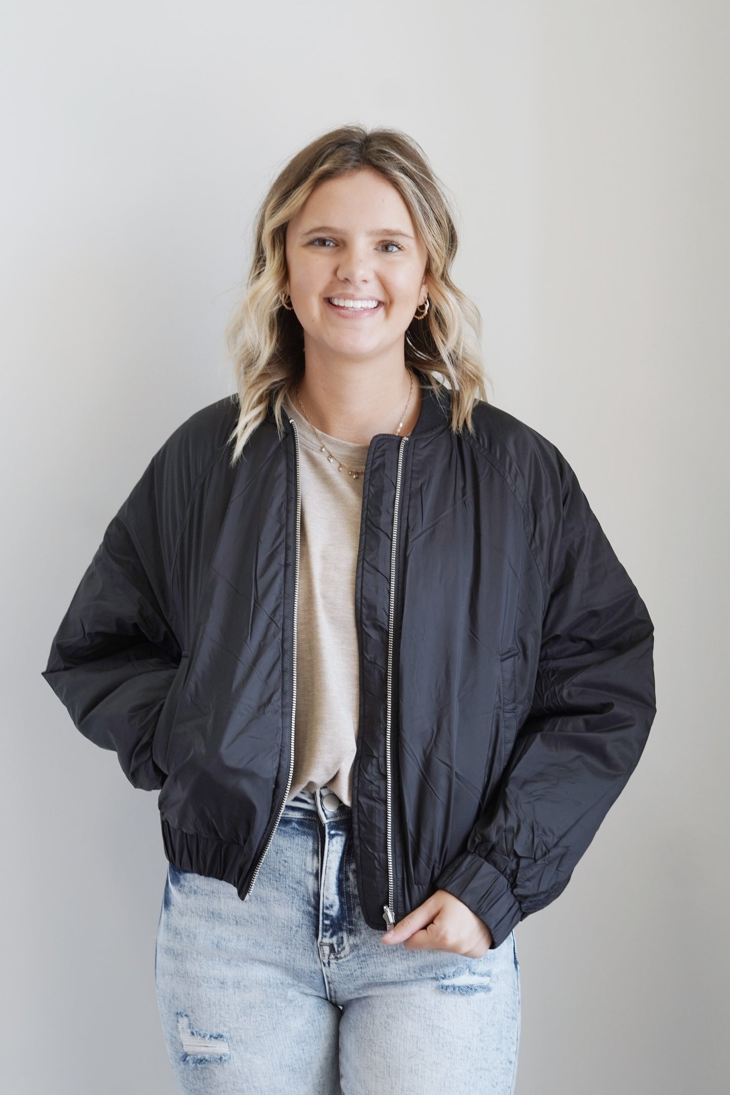 Reversible Nylon Bomber Jacket Zipper Ribbed Collar Reversible: Sleek Side, Quilted Side Color: Black Pockets Long Cinched Sleeves 100% Nylon