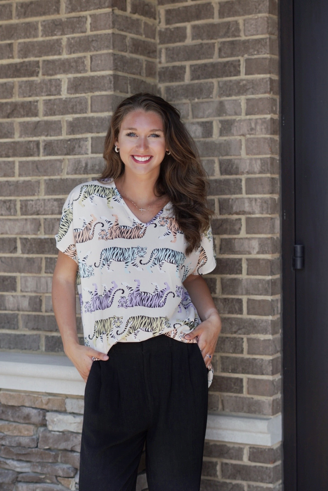 Mae Multicolor Tiger Print Top V- Neckline Cowl Sleeves Multi Color Walking Tigers Print Colors: Beige background; yellow, orange, purple, and blue tigers Full Length Loose Fit 100% Polyester Care: Machine Wash with Like Colors, Tumble Dry Low, Do Not Bleach Model is wearing a size small