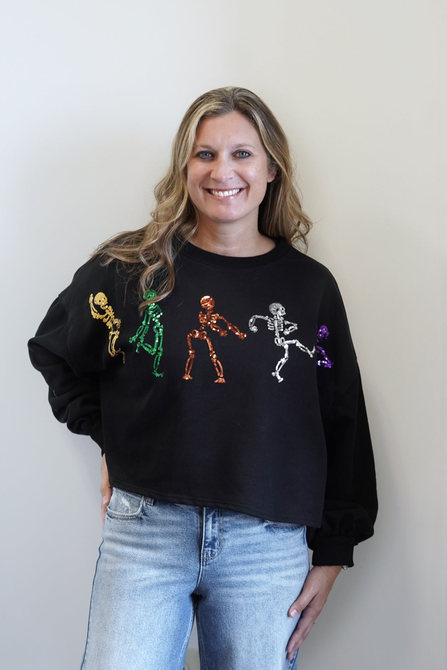 Sassy Skeleton Sequin Sweatshirt Crew Neckline Long Cuffed Sleeves Solid Black Shirt Yellow, Green, Orange, Silver, and Purple Skeletons Skimmer Length 57% Cotton, 43% Polyester