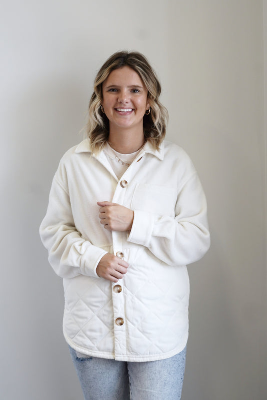 Jump Start Jacket Collared Neckline Long Cuffed Sleeves Quilted Fabric Detail Colors: Sandstone, Brown Buttons Front Pockets Side Slits 100% Polye