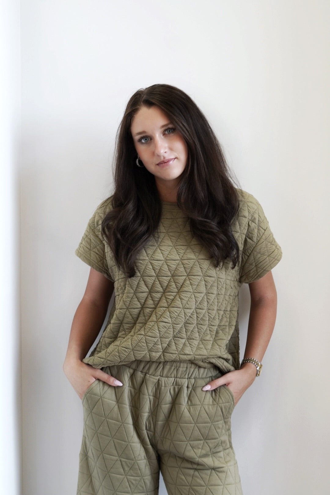 Cozy and Quilted Short Sleeve Top Round Neckline Short Capped Sleeves Quilted Fabric Colors: Olive, Full Length Relaxed Fit 98% Polyester, 2% Spandex