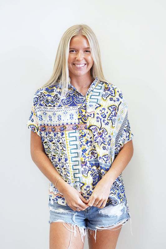 Blakely Blue Mix Satin Top Collar Neckline Short sleeve Button Down Unique design across entire top Colors on top/ Royal Blue,Yellow, Pink, White, Green Full length with back of the top being a few inches longer. 100% Polyester Hand was cold, do not wring or twist. Use only nylon chlorine bleach, line dry. Model is wearing size small