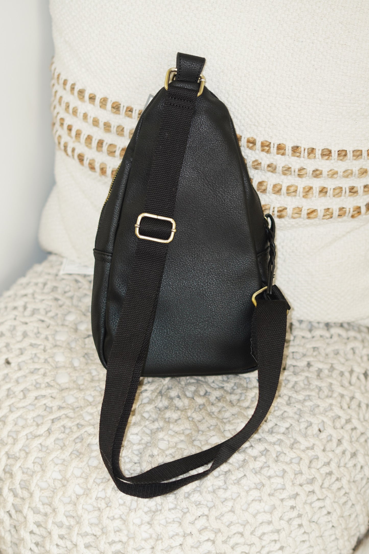 This Nikki Crossbody Backpack is essential this summer! Throw this on leaving the house to run errands or going to a sports event. The perfect colors nude and black will go with any outfit you have on! 8"x13"x2" 2 zipper openings Zipped pocket in the front Braided Zippers Crossbody Strap Black