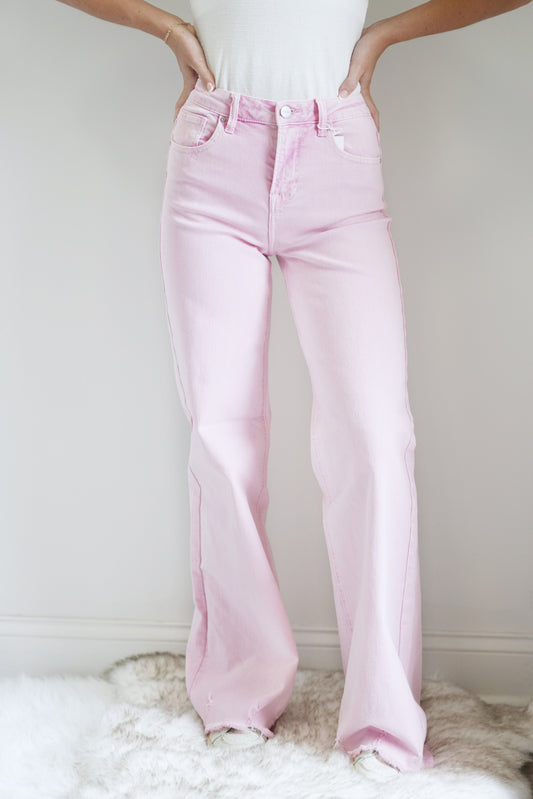 Payt Acid Pink High Rise Jeans High Rise Waistline Wide Leg Raw Hem on the Leg Zipper Fly Full Length 98% Cotton, 2% Spandex Turn Inside Out, Machine Wash Cold, Hang to Dry Model is wearing a size 1