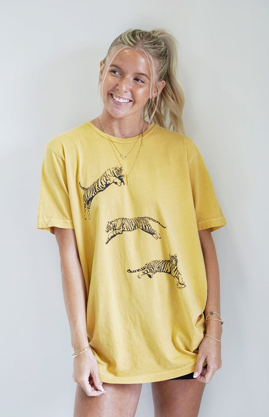 Julie Jumping Tiger Graphic Tee Crew Neckline Short Sleeve Jumping Tiger Feature Color/Mustard True to size fit 100% Cotton Machine wash warm inside out with like colors. Model is wearing size: medium