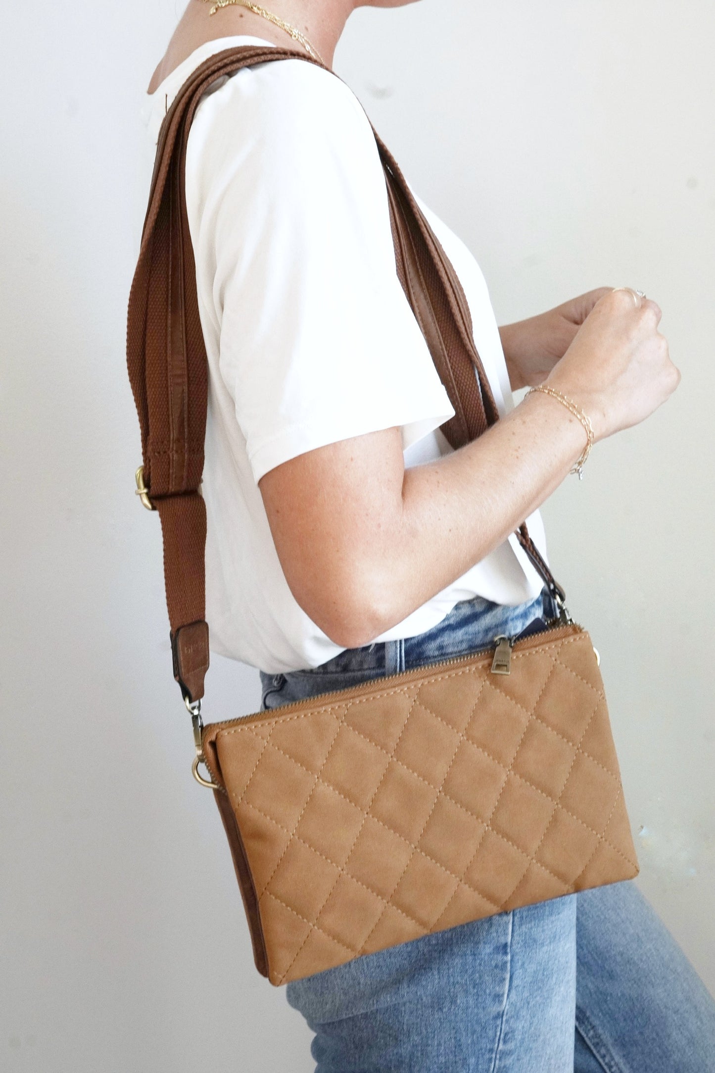 Izzy Quilted Oversized Crossbody Wallet Quilted Pattern Expandable Two Large Inner Pockets Middle Zipper Pocket Six Credit Card Slots Removeable Adjustable Guitar Strap and Wrist Strap Approx 10 in. x 6 1/2 in. x 1 1/2 in. Bottom expands to approx. 5 in. brown color