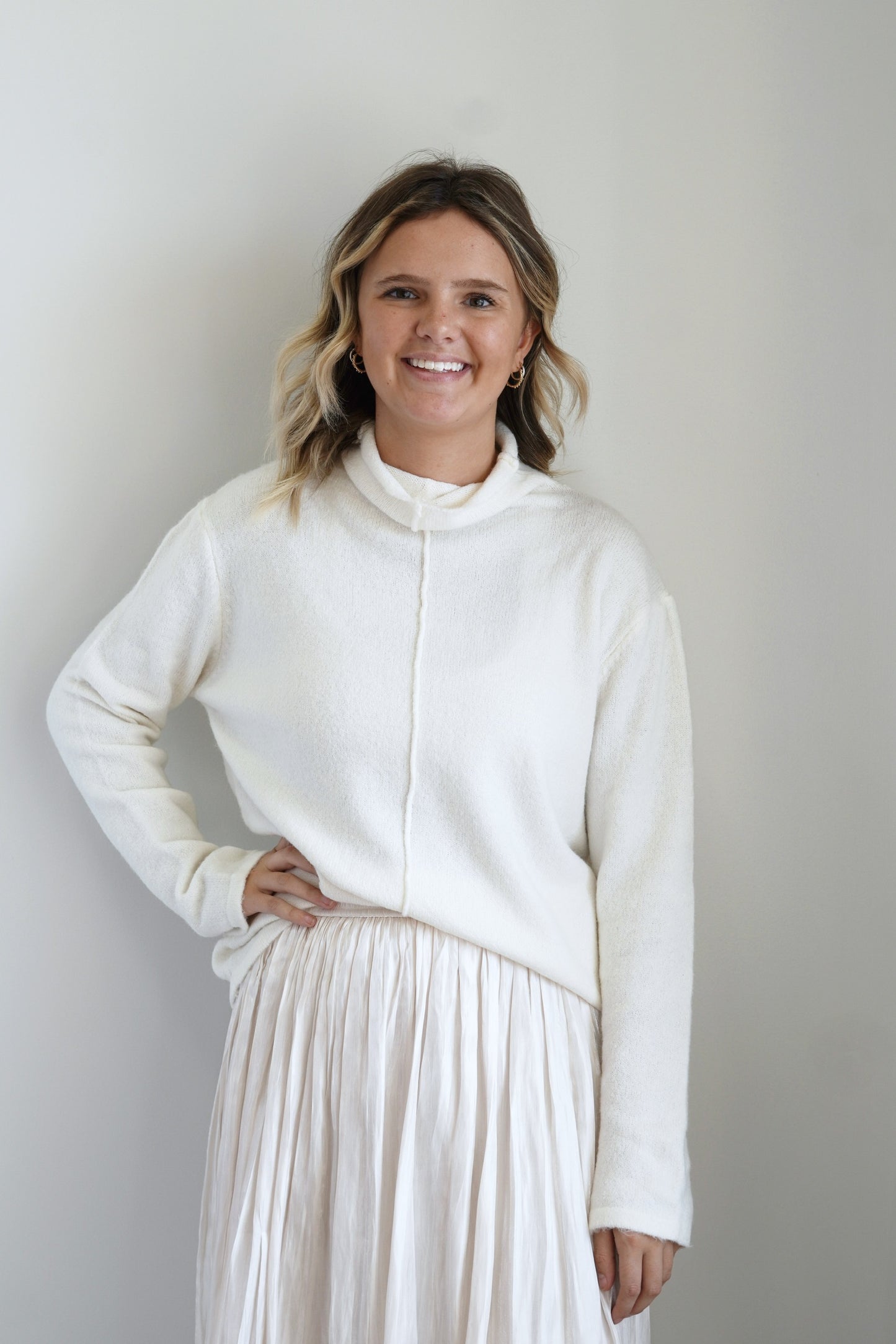 Mori Mock Neck Cozy Sweater Mock Neckline Long Sleeves Vertical Hem Line on Front Colors: Cream Relaxed Fit Full Length 47% Polyester, 35% Acrylic, 15% Nylon, 3% Spandex