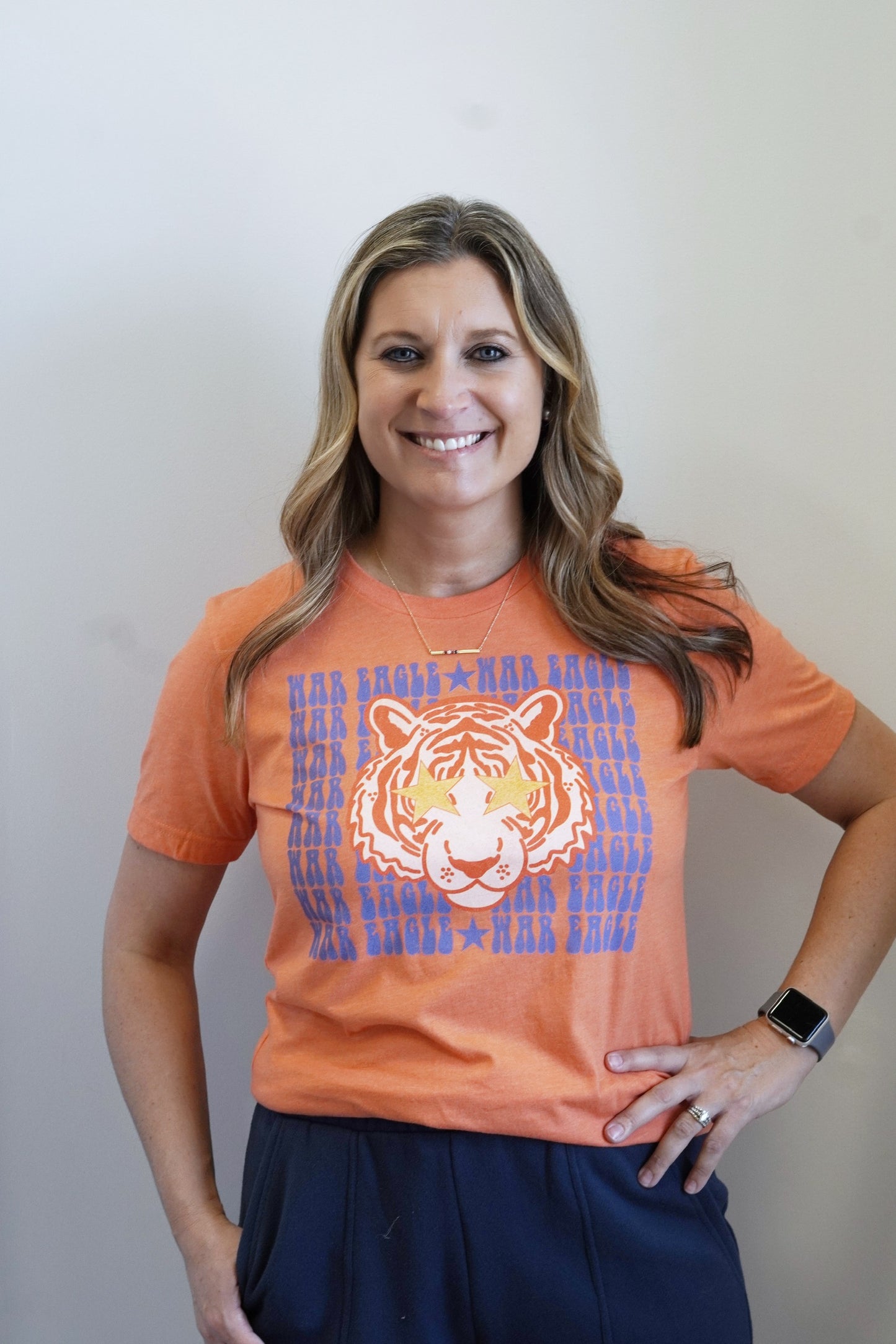 War Eagle Tiger Graphic Tee Crew Neckline Short Sleeves Orange Base Navy "War Eagle" Lettering Tiger w/ Star Eyes Graphic Full Length Relaxed Fit 60% Cotton, 40% Polyester