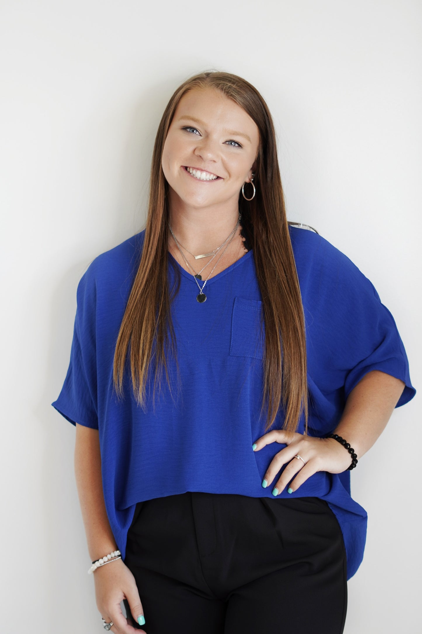 Sara Flow Blouse V-Neck Pocket Flow Color: Royal Blue 100% Polyester Hand Wash Cold Do Not Bleach, Hang Or Line Dry, Low Iron Model is wearing size: Small