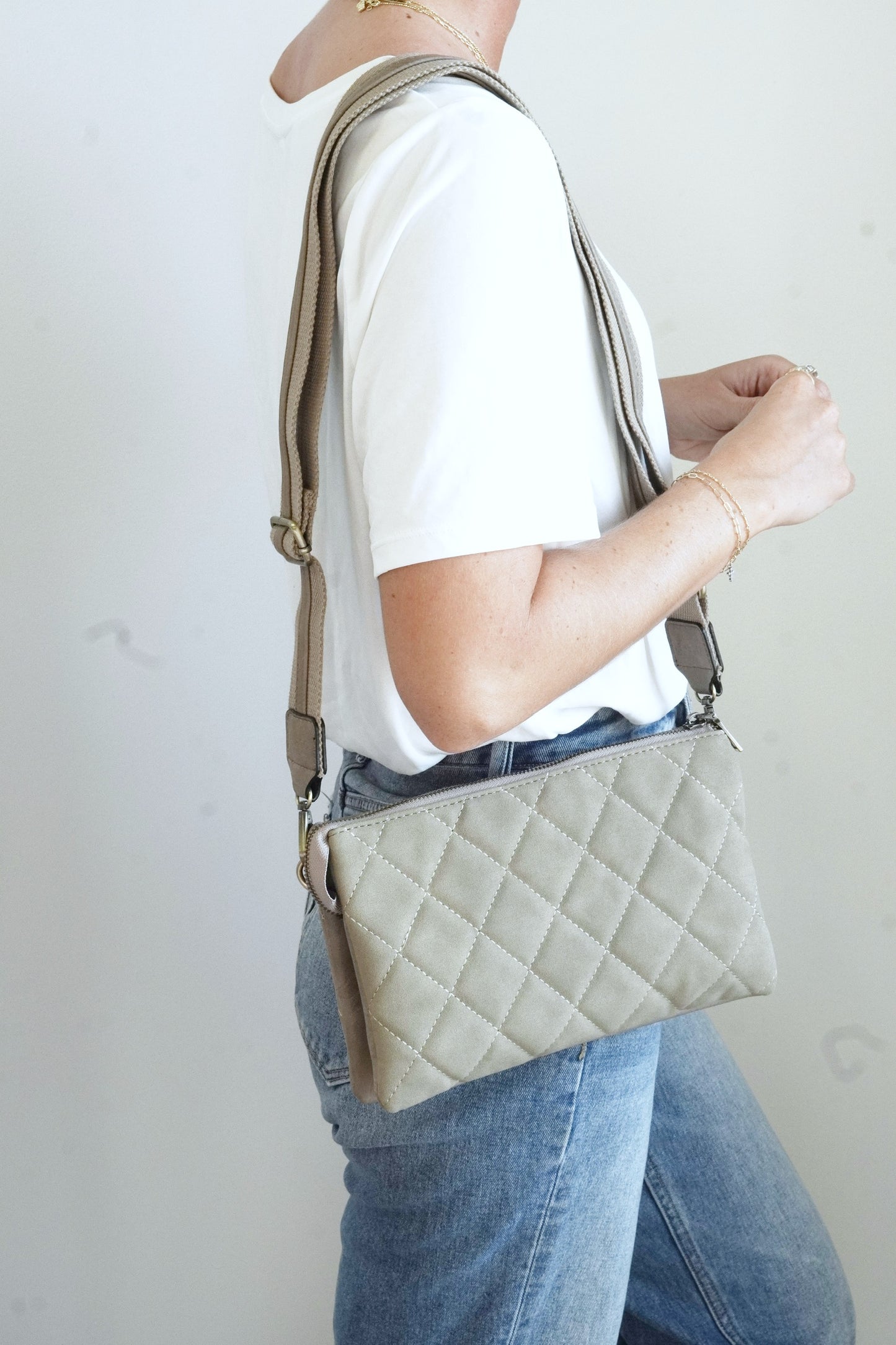 Izzy Quilted Oversized Crossbody Wallet Quilted Pattern Expandable Two Large Inner Pockets Middle Zipper Pocket Six Credit Card Slots Removeable Adjustable Guitar Strap and Wrist Strap Approx 10 in. x 6 1/2 in. x 1 1/2 in. Bottom expands to approx. 5 in. grey taupe color