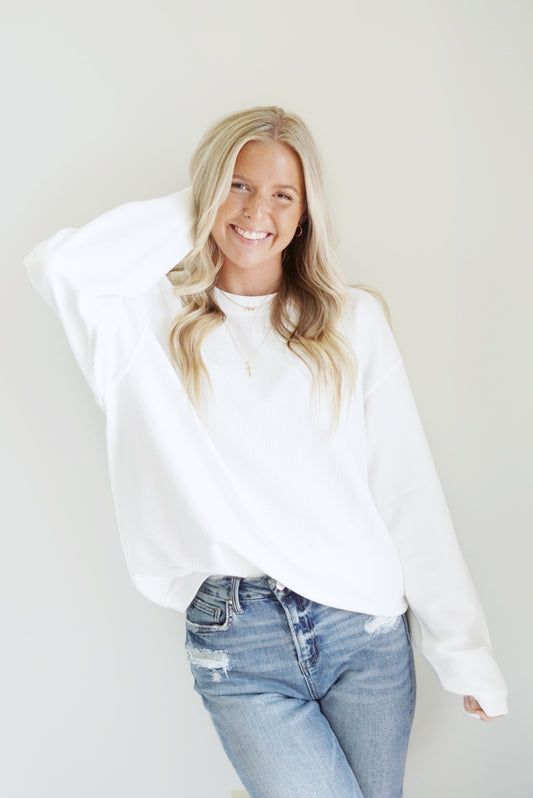 Calla Corded Crew Everyday Sweatshirt Crew Neckline Long Sleeve Corded Material Colors: Pink, Ivory, Sky Blue Full Length Relaxed Fit 100% Cotton Care: Machine Wash Carefully in Cold Water, Lay Flat to Dry