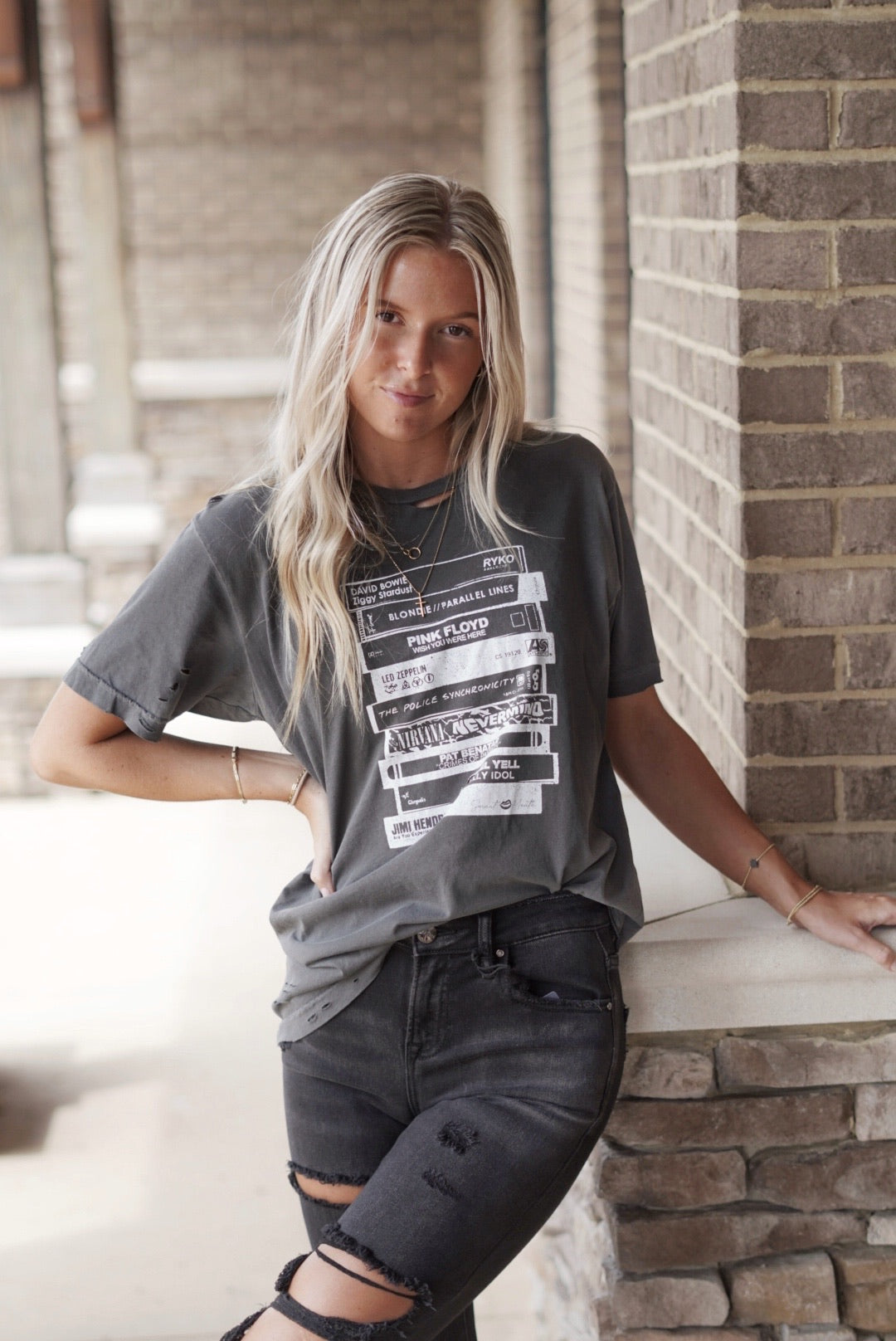 Maeva Music Lover Graphic Tee Crew Neckline Short Sleeve Distressed T-Shirt Stacked Tapes on front of shirt Dark Grey True to size Sizes medium-XXL Model is wearing size: 100% Cotton Machine wash warm, inside out with like colors Model is wearing a size medium