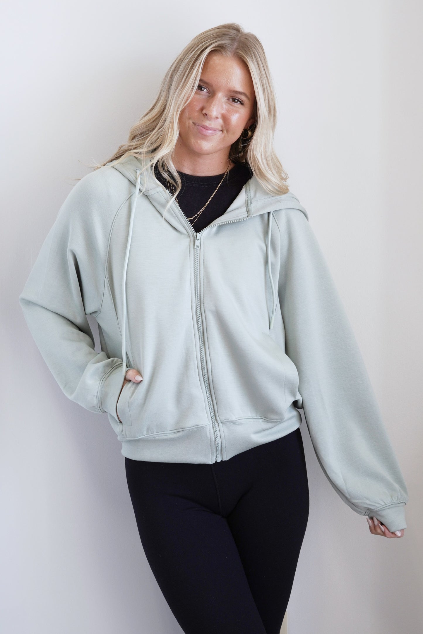 Daisy Scuba Hooded Jacket Scuba Hood Drawstrings at Neckline Long Cuffed Sleeves Front Pockets Sage Color Relaxed Fit Full Length 49% Polyester, 45% Cotton, 6% Sp
